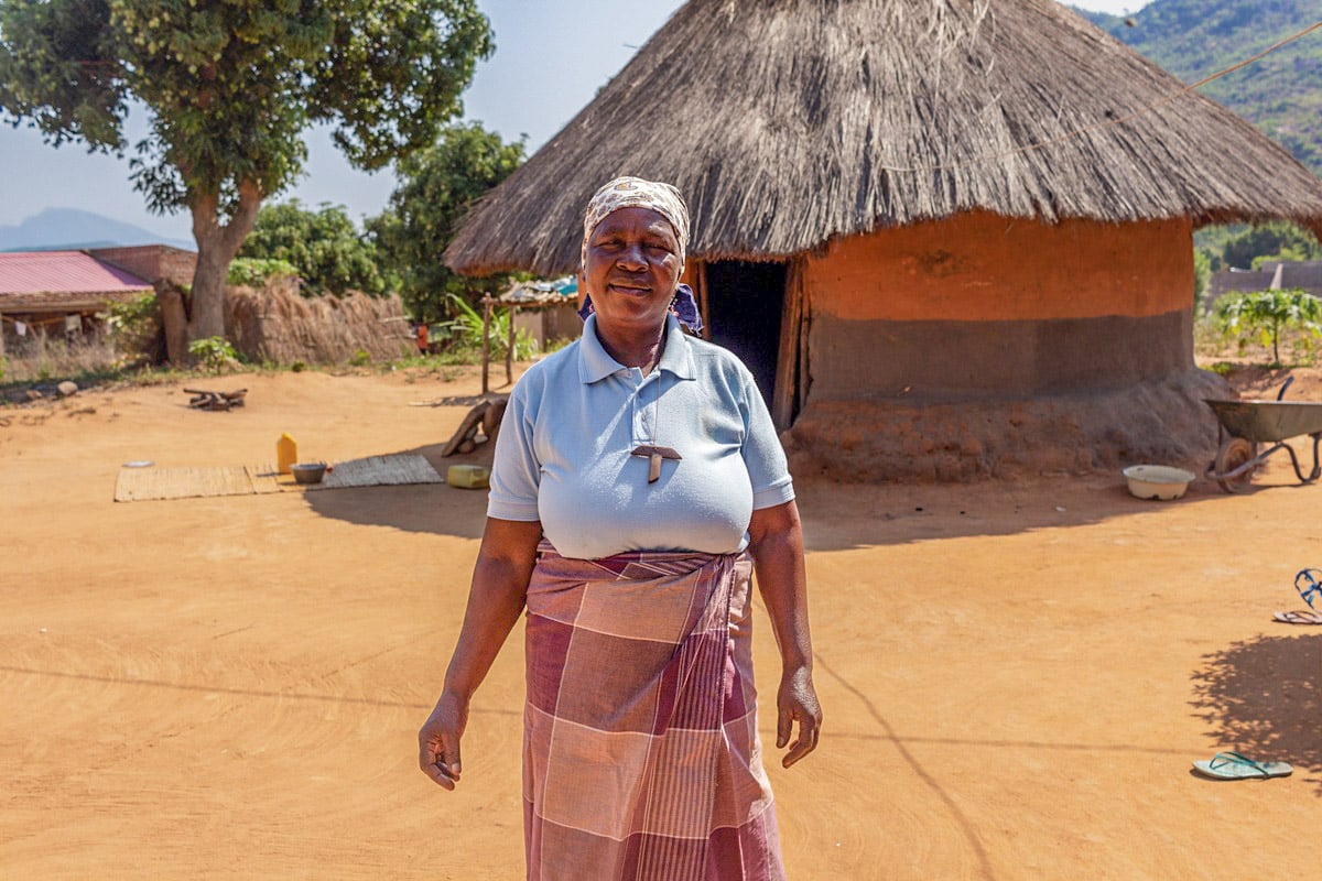 femme devant sa maison rurale au Mozambique