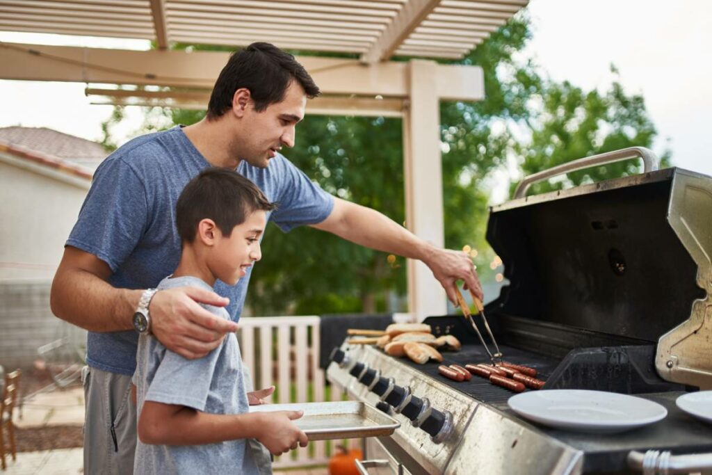 père et fils dans leur cuisine d'été