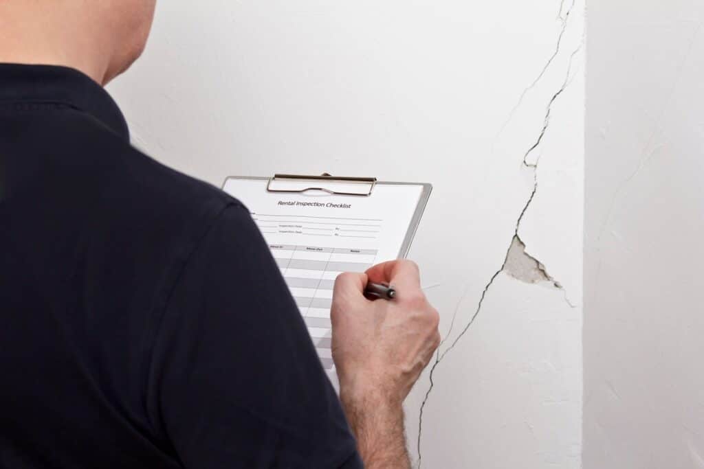 expert en bâtiment analyse fissure dans un mur